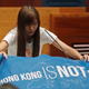 Newly elected lawmake Yau Wai-ching of Youngspiration displays a banner with words reading “Hong Kong is not China” as she takes oath in the new legislature Council in Hong Kong, Wednesday, Oct. 12, 2016. A swearing-in ceremony to kick off Hong Kong's legislative session descended into farce Wednesday as newly elected pro-democracy lawmakers intentionally mangled their oaths in a show of defiance against Beijing. The new crop of lawmakers, elected last month amid swelling anti-China sentiment, object to the oath's requirement to pledge allegiance to the "Hong Kong Special Administrative Region of the People's Republic of China" and its Basic Law constitution.